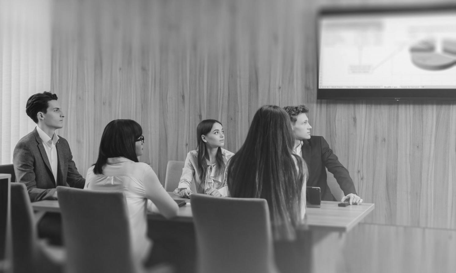 Equipa de analistas financeiros em sessão colaborativa de análise de dados